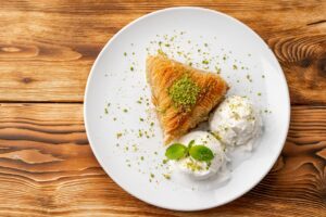Close up photo of Turkish baklava served with ice cream