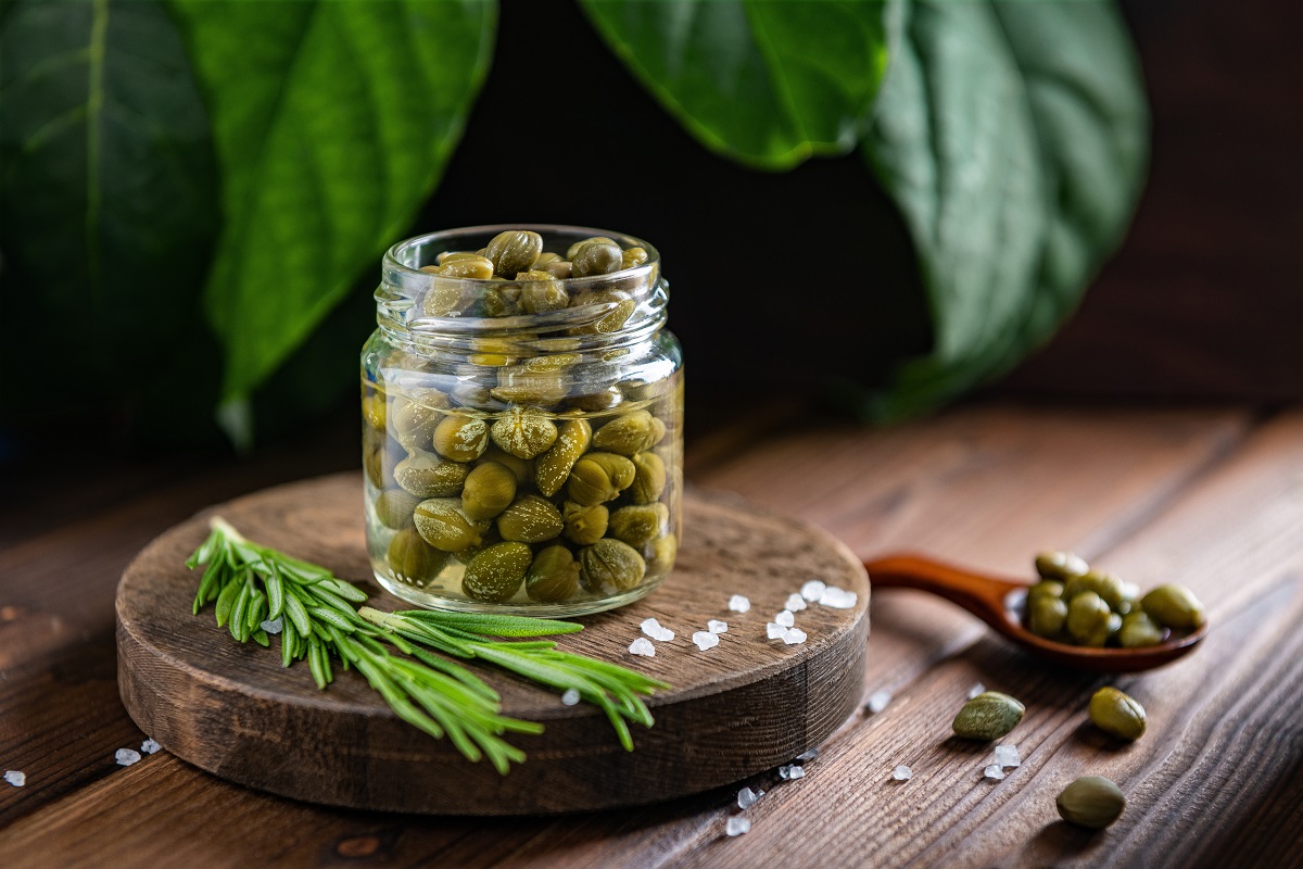 Capers,In,A,Transparent,Jar,On,A,Wooden,Stand,With