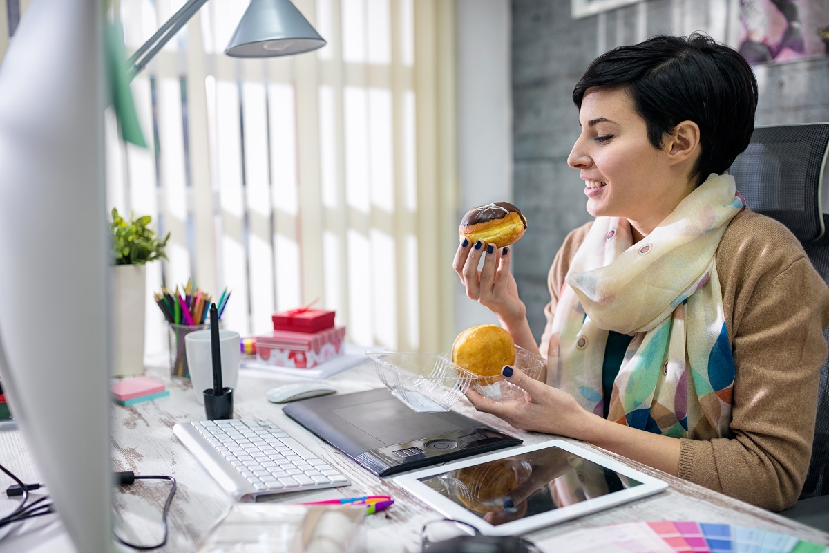 satisfied designer eating donuts