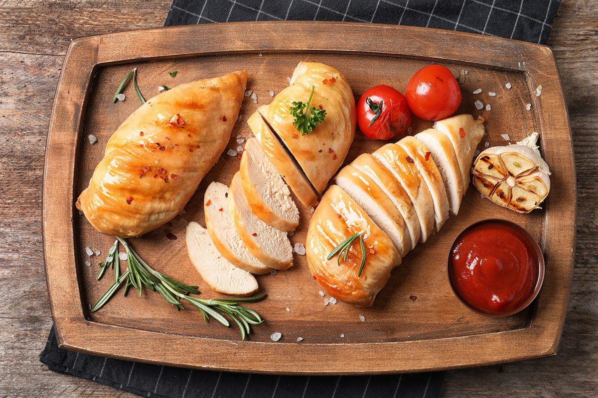 Wooden,Board,With,Fried,Chicken,Breasts,And,Sauce,On,Table,