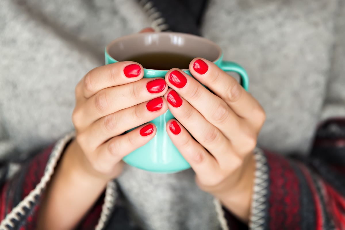 Female,Hands,Holding,A,Mug,Of,Hot,Tea