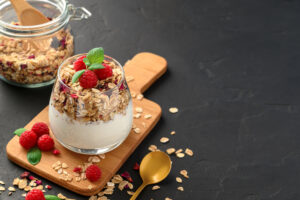 Parfait,Yogurt,With,Granola,And,Raspberries,In,A,Glass,,Black