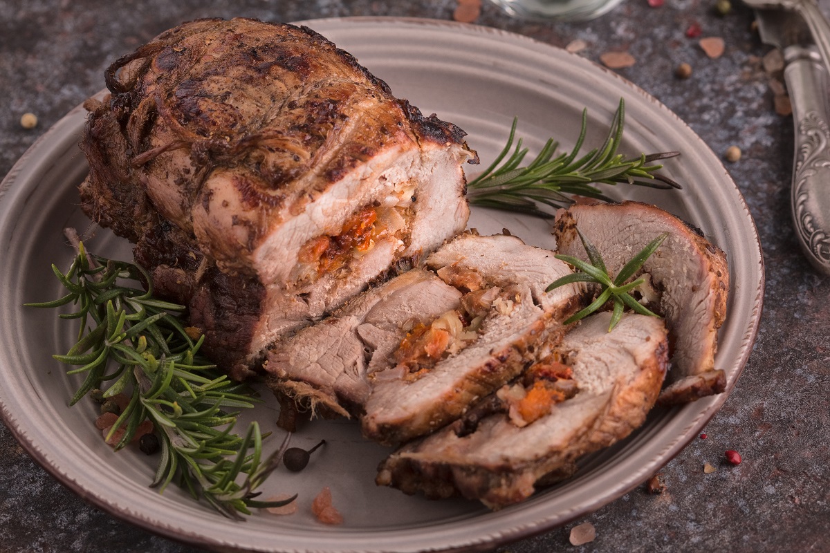Roasted,Pork,Roll,Stuffed,With,Dried,Apricots,,Cheese,And,Walnuts.