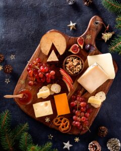Christmas,Cheese,Platter,With,Grapes,,Nuts,,Figs,On,A,Dark