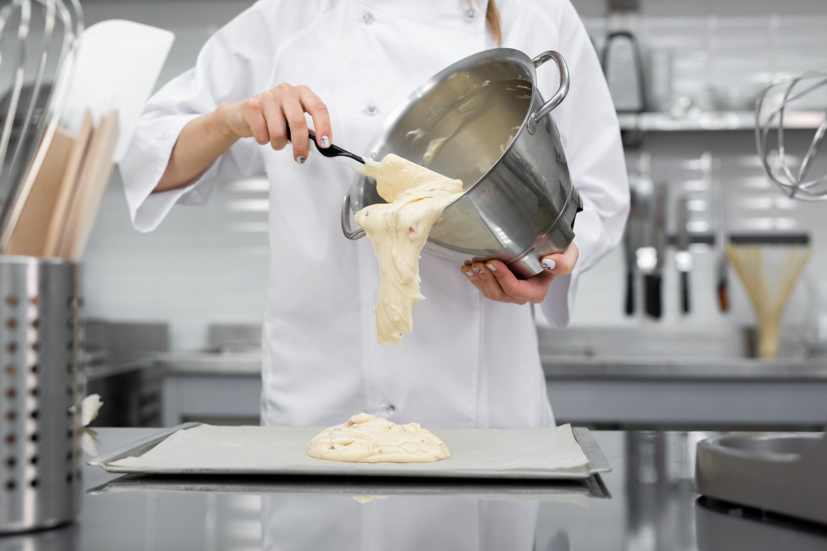 Pastry,Chef,Pours,The,Biscuit,On,The,Baking,Parchment.