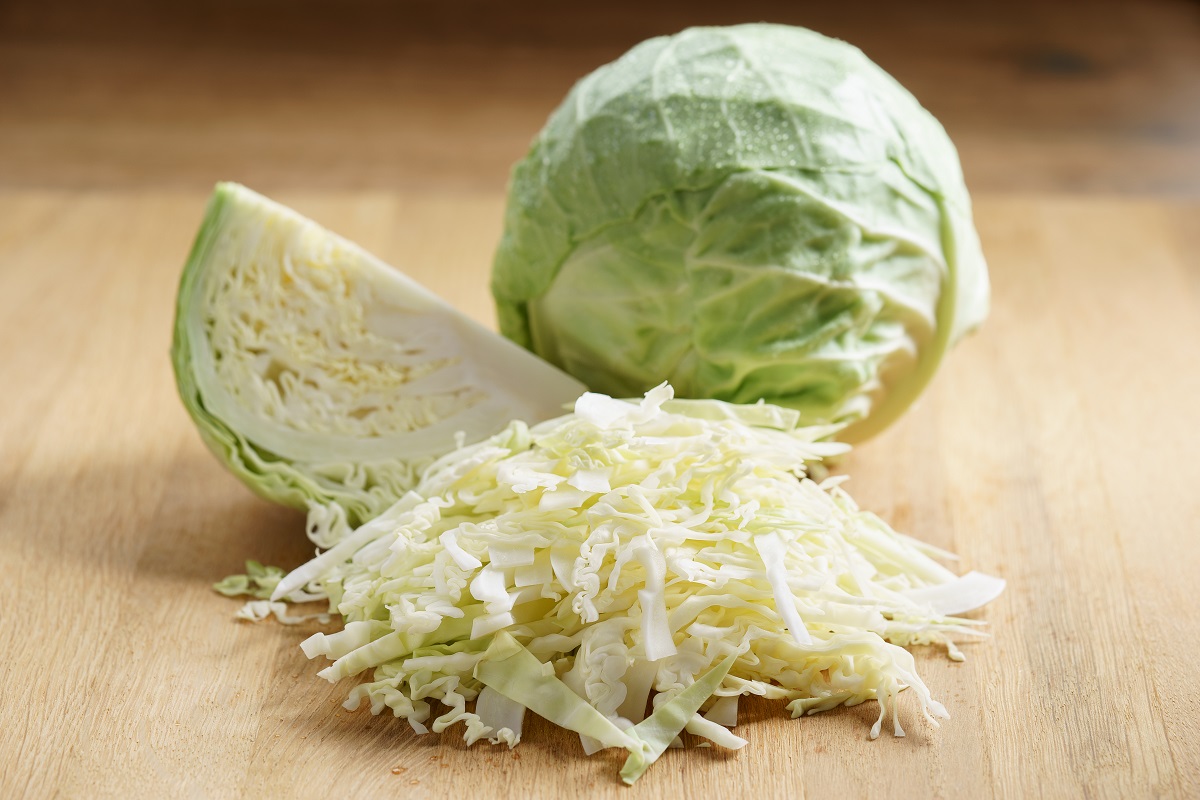 Fresh,Green,Cabbage,Cut,Half,On,Wooden,Background