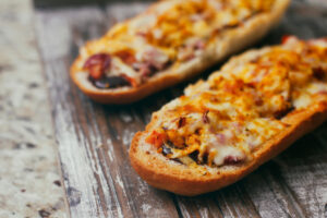 French,Baguette,Sandwich,With,Assorted,Filling.,Dish,On,Wooden,Table.