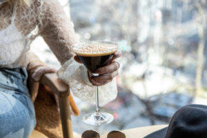 Close,Up,View,Of,A,Woman’s,Hand,Picking,A,Martini