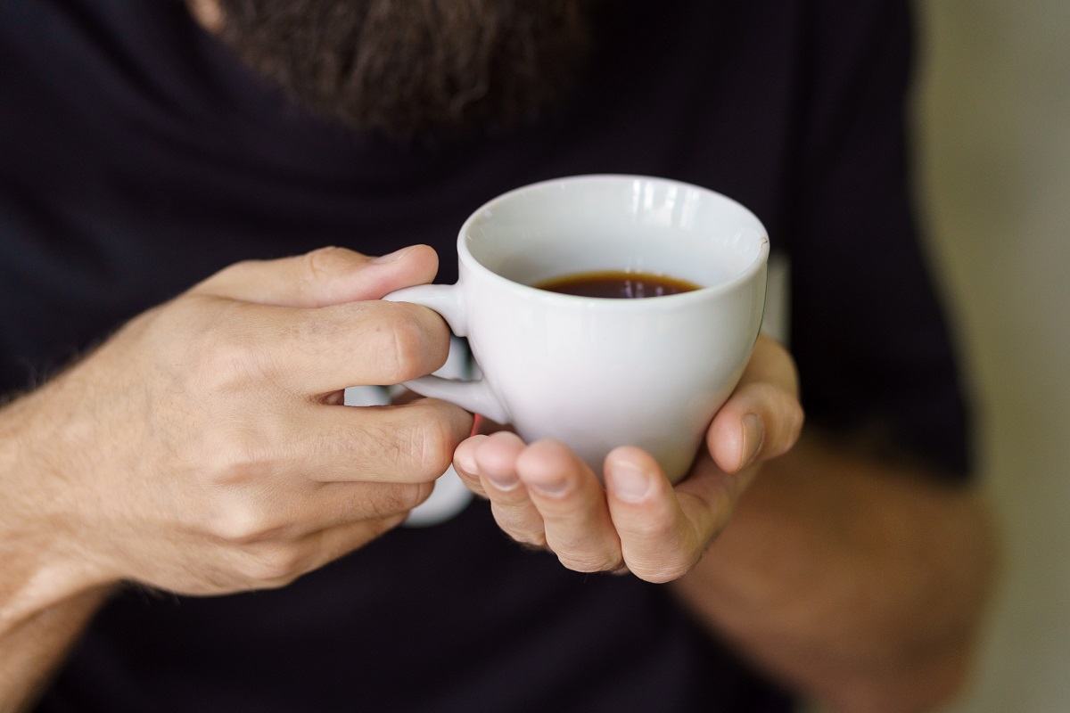 Black,Coffee,In,Hands,On,A,Dark,Background