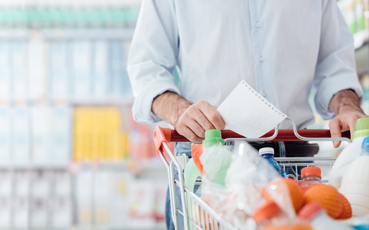 Man,At,The,Supermarket,Shopping,With,A,Grocery,List,And