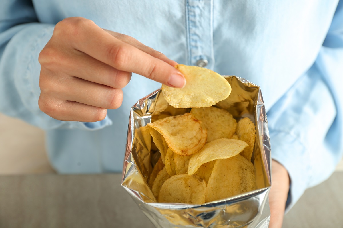 Woman,Eating,Tasty,Potato,Chips,,Closeup