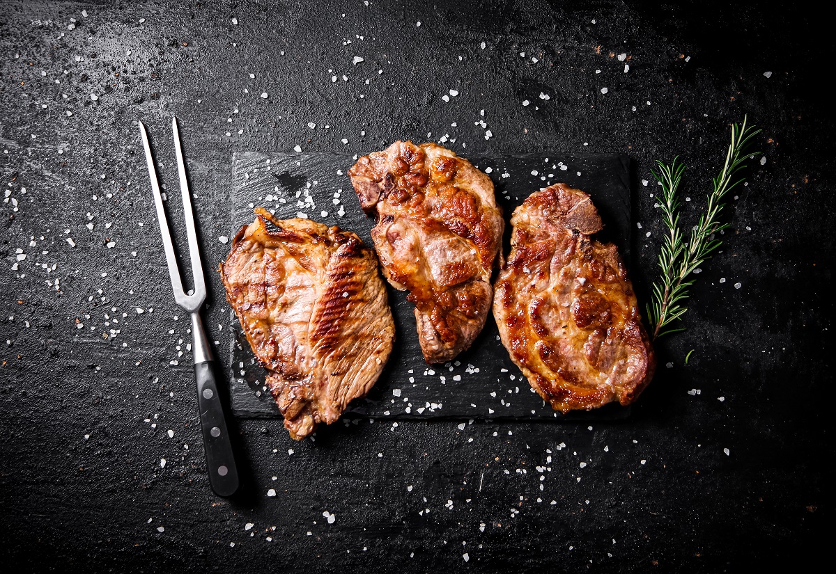 Grilled,Pork,Steak,With,A,Sprig,Of,Rosemary.,On,A