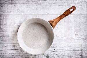 White,Frying,Pan,On,White,Rustic,Table.,Ceramic,Frying,Pan