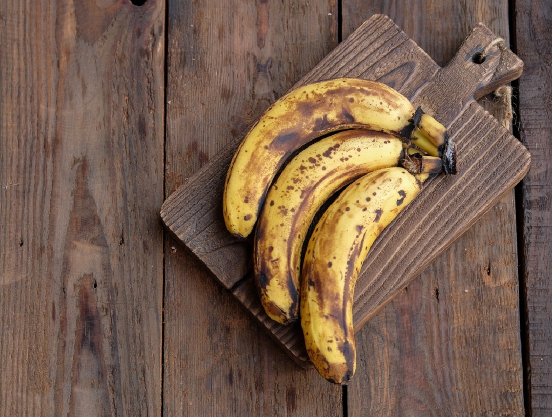 Three,Ripe,Banana,At,Wooden,Tray,And,Textured,Wood,Table