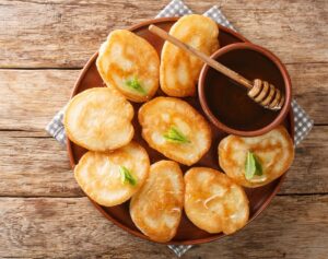 Authentic,Tiganites,Greek,Pancakes,With,Honey,Close-up,In,A,Plate