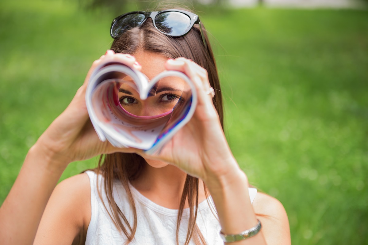 A,Young,Brunette,Woman,Outdoors,In,A,Park,Looking,Through