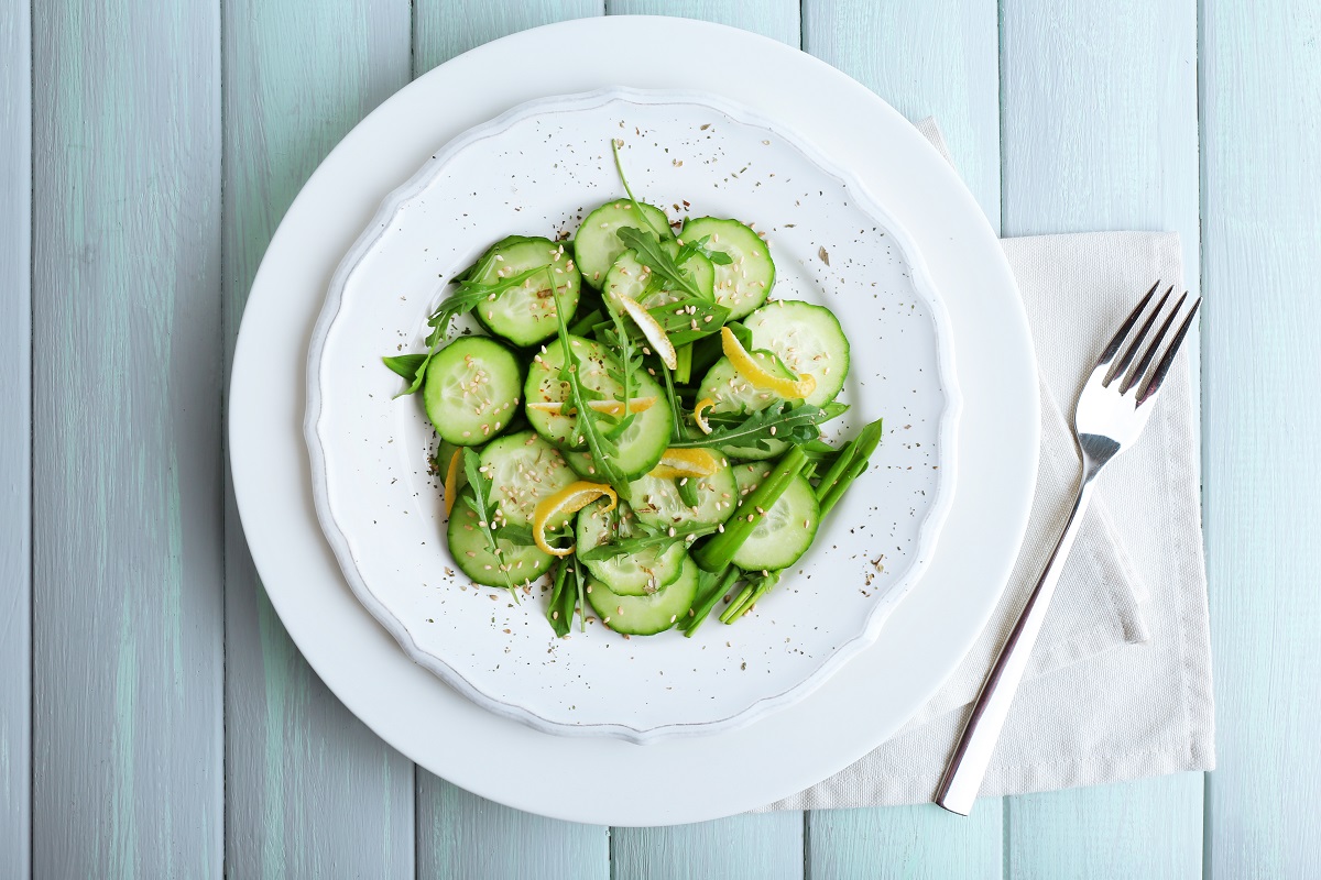 Green,Salad,With,Cucumber,,Arugula,And,Lemon,Peel,On,Wooden