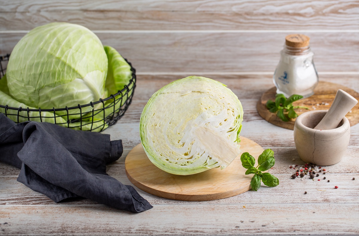 Beautiful,Juicy,Green,Cabbage,In,A,Basket,,On,A,Wooden