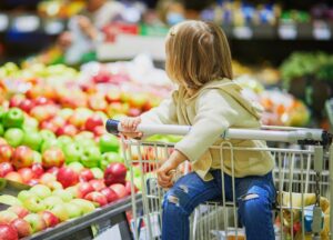 Adorable,Toddler,Girl,Sitting,In,The,Shopping,Cart,In,A