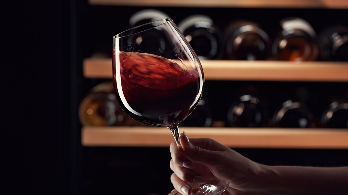 Close,Up,Female,Hand,Swirling,Red,Wine,In,Wine,Glass.
