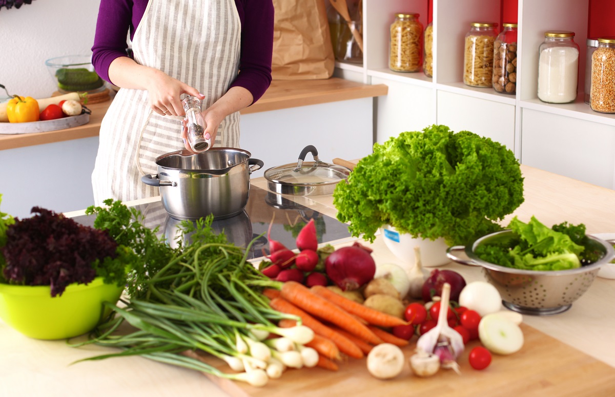 Young,Woman,Cooking,In,The,Kitchen.,Healthy,Food