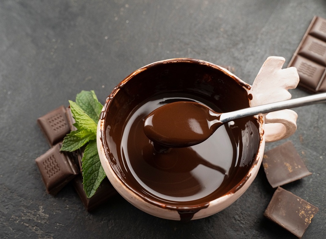 Pastry,Chef,Mixes,Hot,Chocolate,With,Spoon,In,Bowl,,Top