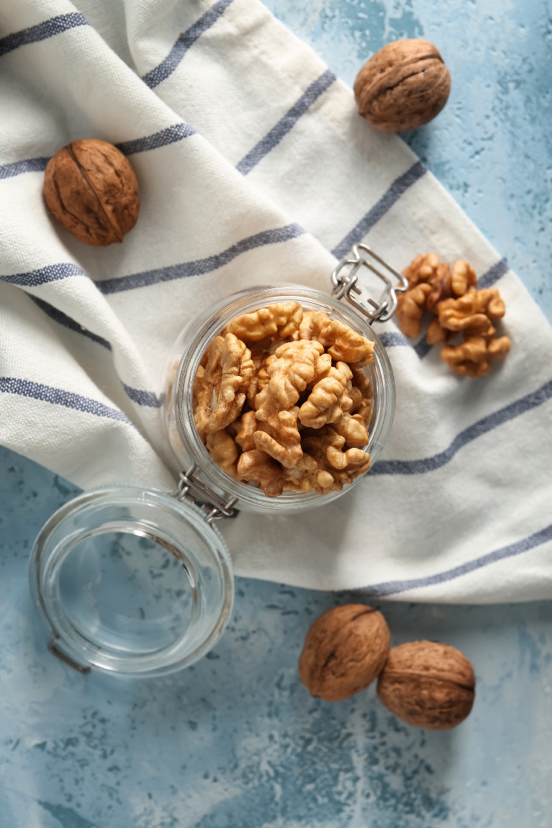 Glass,Jar,With,Shelled,Walnuts,On,Table