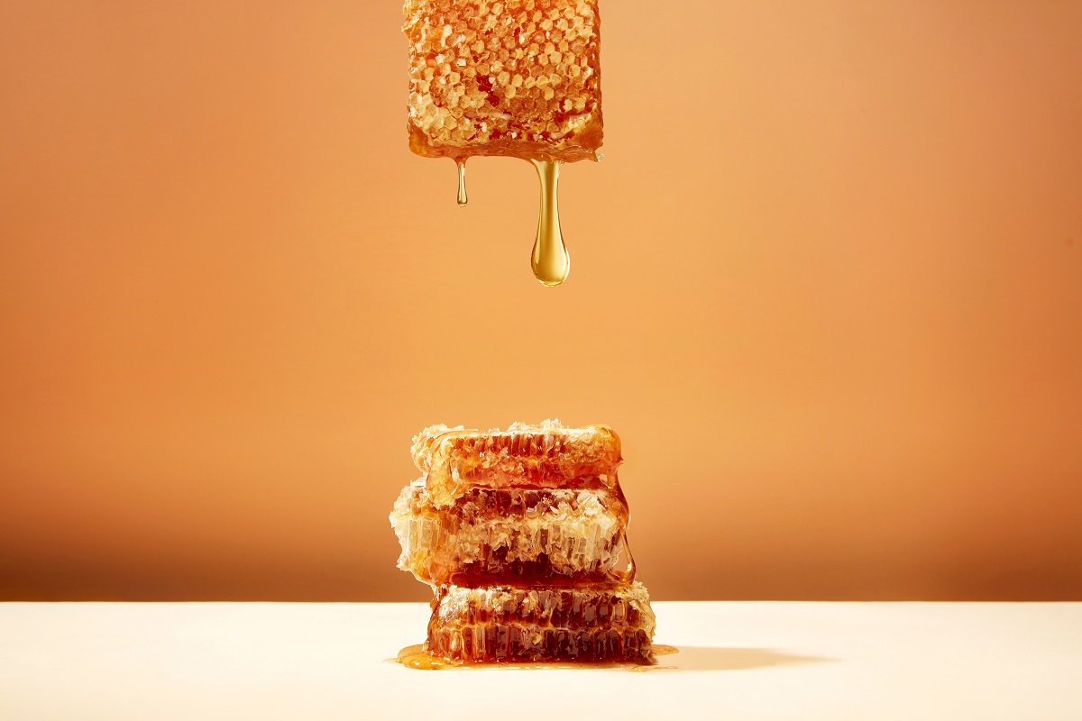 Honeycomb,And,Honey,On,Yellow,Background
