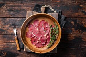 Pastrami,Slices,,Dried,Beef,Meat,With,Herbs,In,Wooden,Plate.