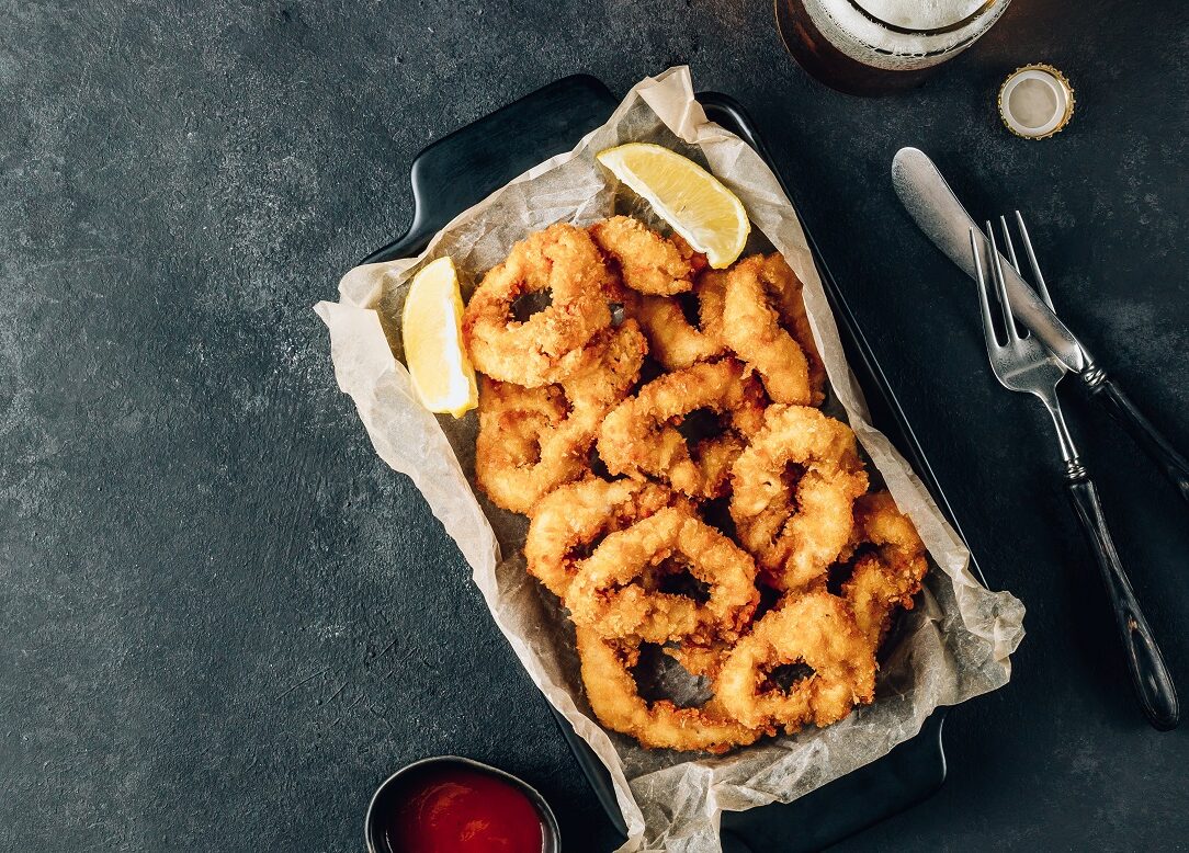 Rings,Of,Squid,With,Lemon,And,Beer,On,A,Black