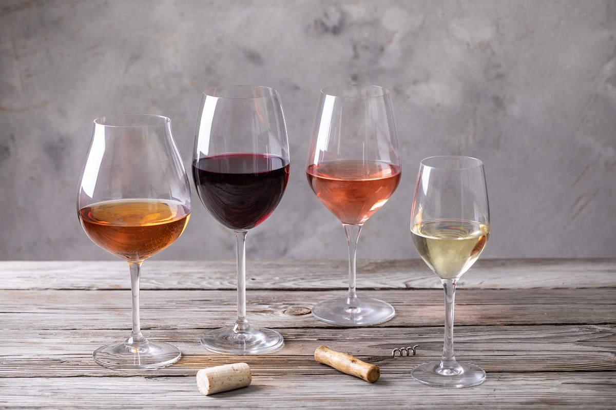 Four,Kinds,Of,Wine,In,Wineglasses,On,Old,Wooden,Table.