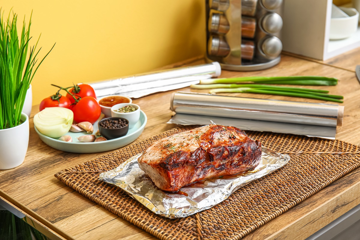 Aluminium,Foil,With,Tasty,Baked,Meat,,Vegetables,And,Spices,On