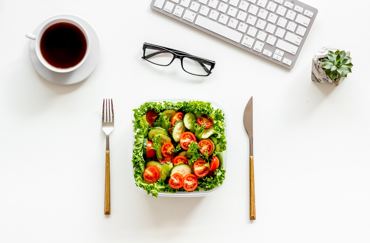 Healthy,Dinner,In,Lunch,Box,Near,Keyboard,And,Tea,On