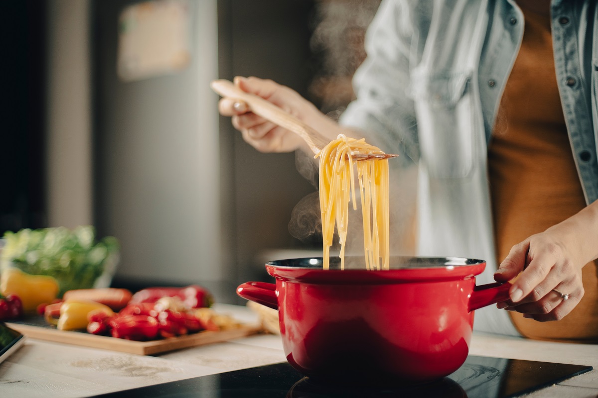 Beautiful,Pregnant,Woman,Preparing,Delicious,Food.,Smiling,Woman,Cooking,Pasta