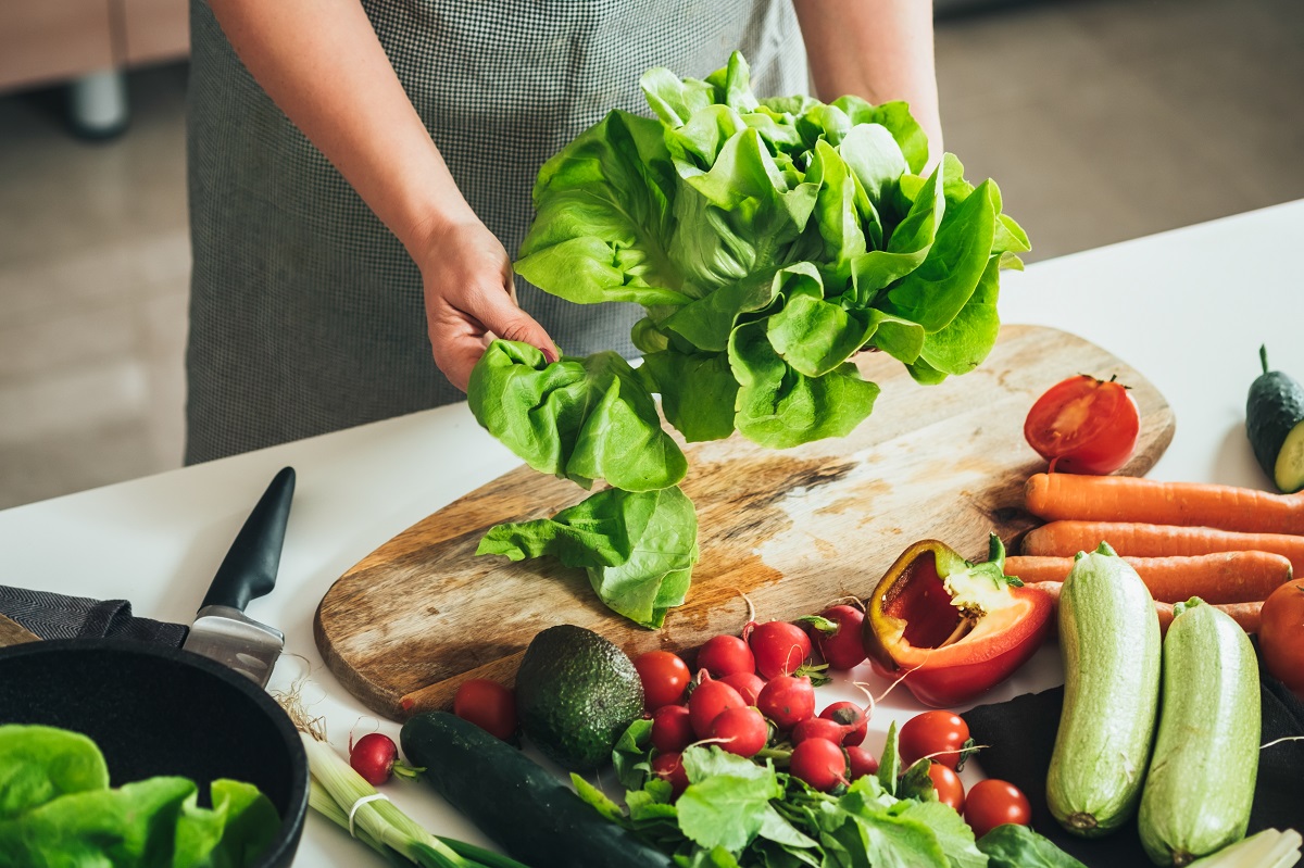 Close,Up,Photo,Of,Woman,Hands,Making,Fresh,Salad,On
