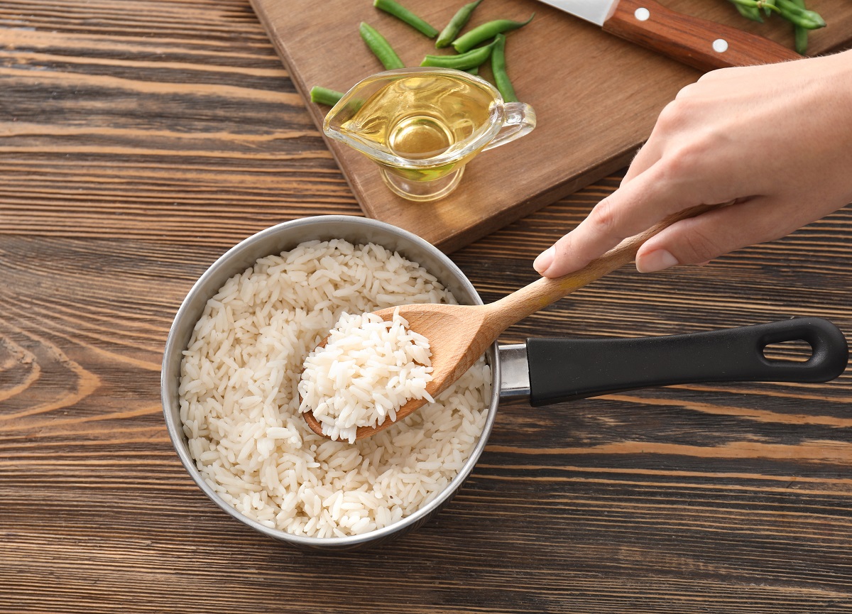 Woman,With,Saucepan,Full,Of,Tasty,Rice