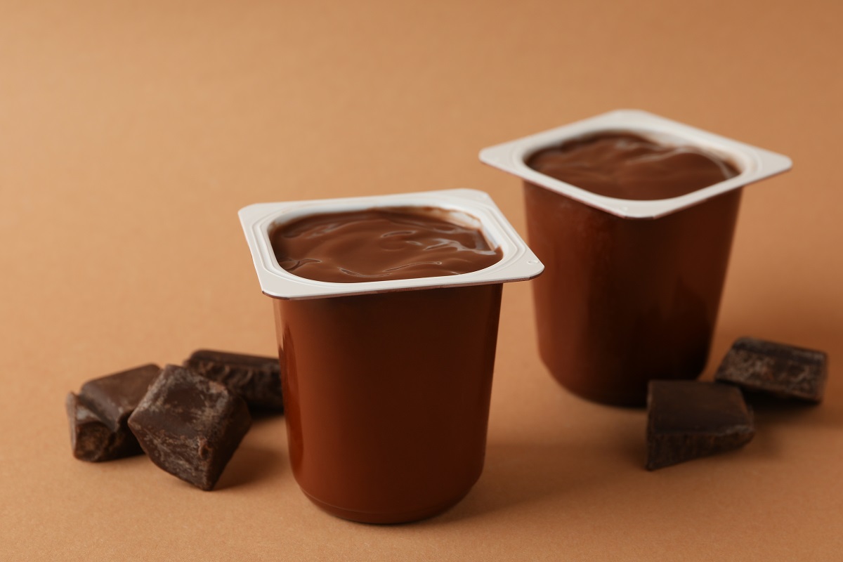 Plastics,Cups,Of,Chocolate,Yogurt,On,Brown,Background