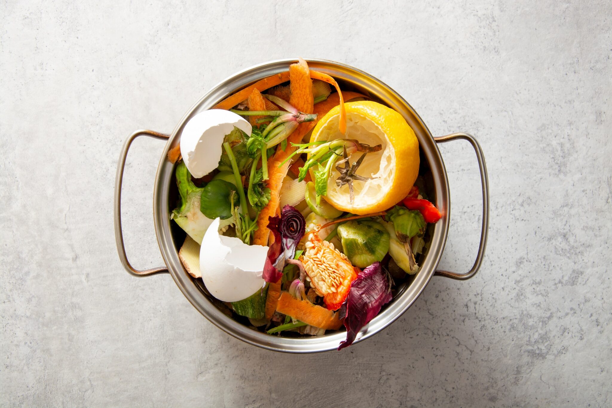 Organic,Food,Waste,In,Pot,On,Kitchen,Table.,Environmentally,Responsible