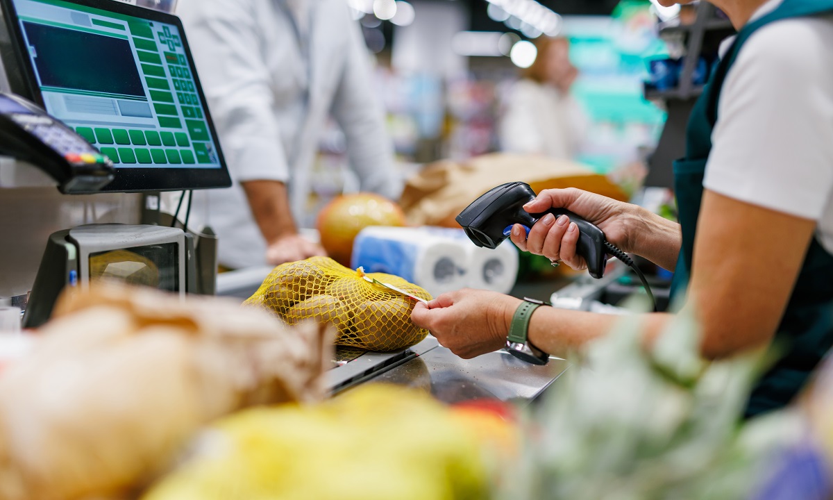 Supermarket,Cashier,Scanning,Potatoes,At,The,Checkout,Counter,,Processing,Groceries