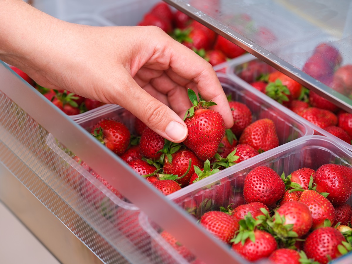 A,Woman,Taking,A,Organic,Red,Strawberry,Out,Of,A
