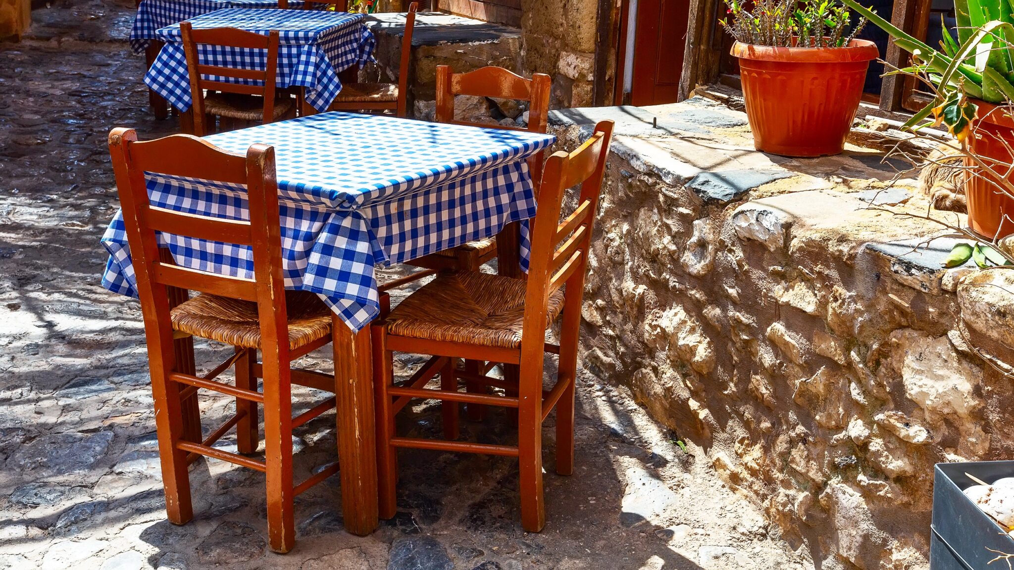 Street,View,With,Blue,And,White,Cloth,Tables,In,Greek