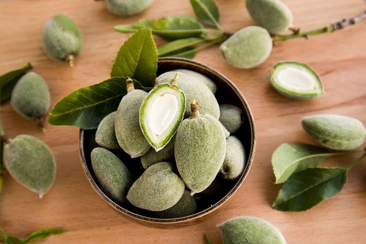 Fresh,,Unripe,Green,Almonds,In,Bamboo,Bowl,With,Sliced,And