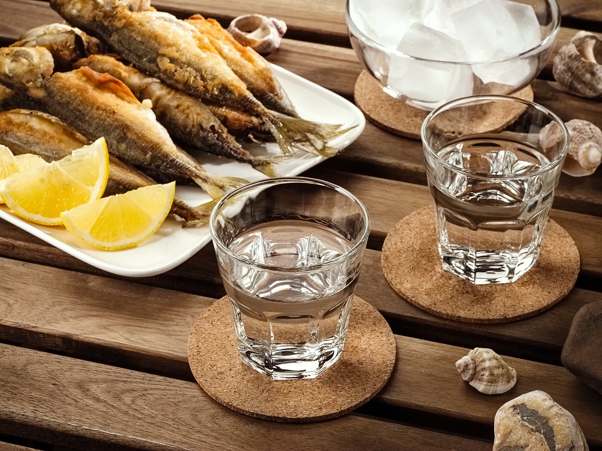 Two,Glasses,Tsipouro,Raki,With,Fried,Fish,On,A,Wooden