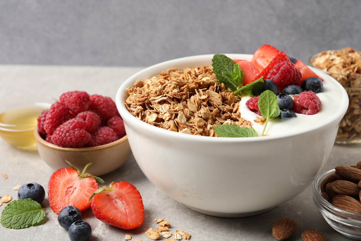 Tasty,Granola,With,Berries,And,Yogurt,In,Bowl,On,Grey