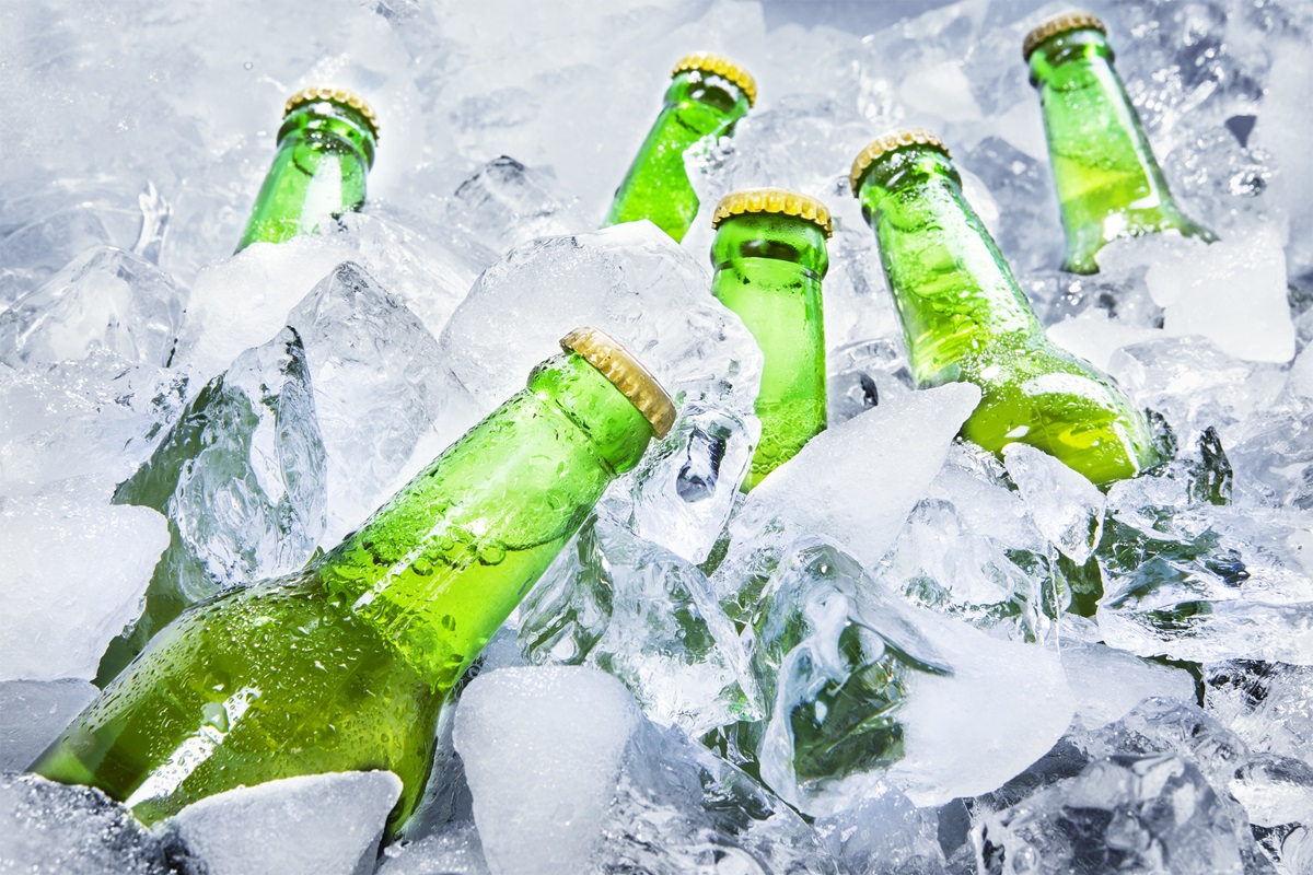 Closeup,Of,Green,Beer,Bottles,Getting,Cool,In,Ice,Cubes.
