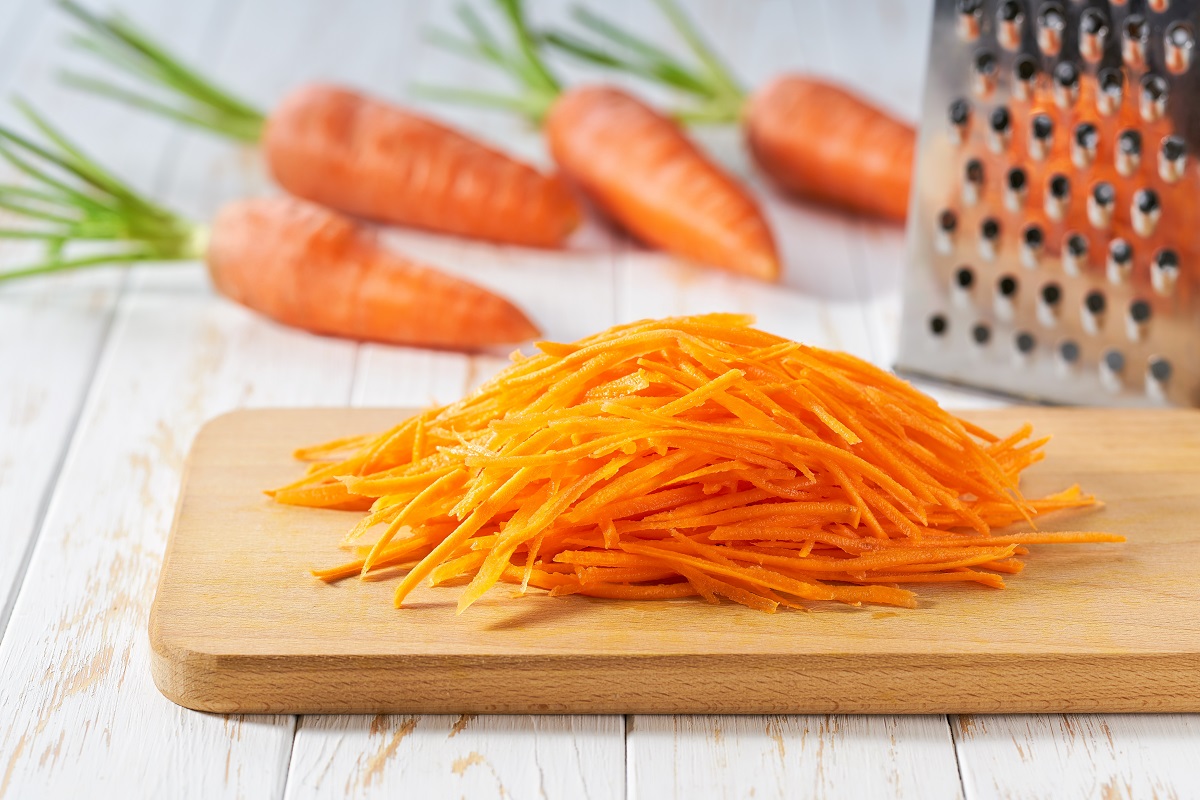 Fresh,Grated,Carrots,On,A,Cutting,Board,,Selective,Focus.