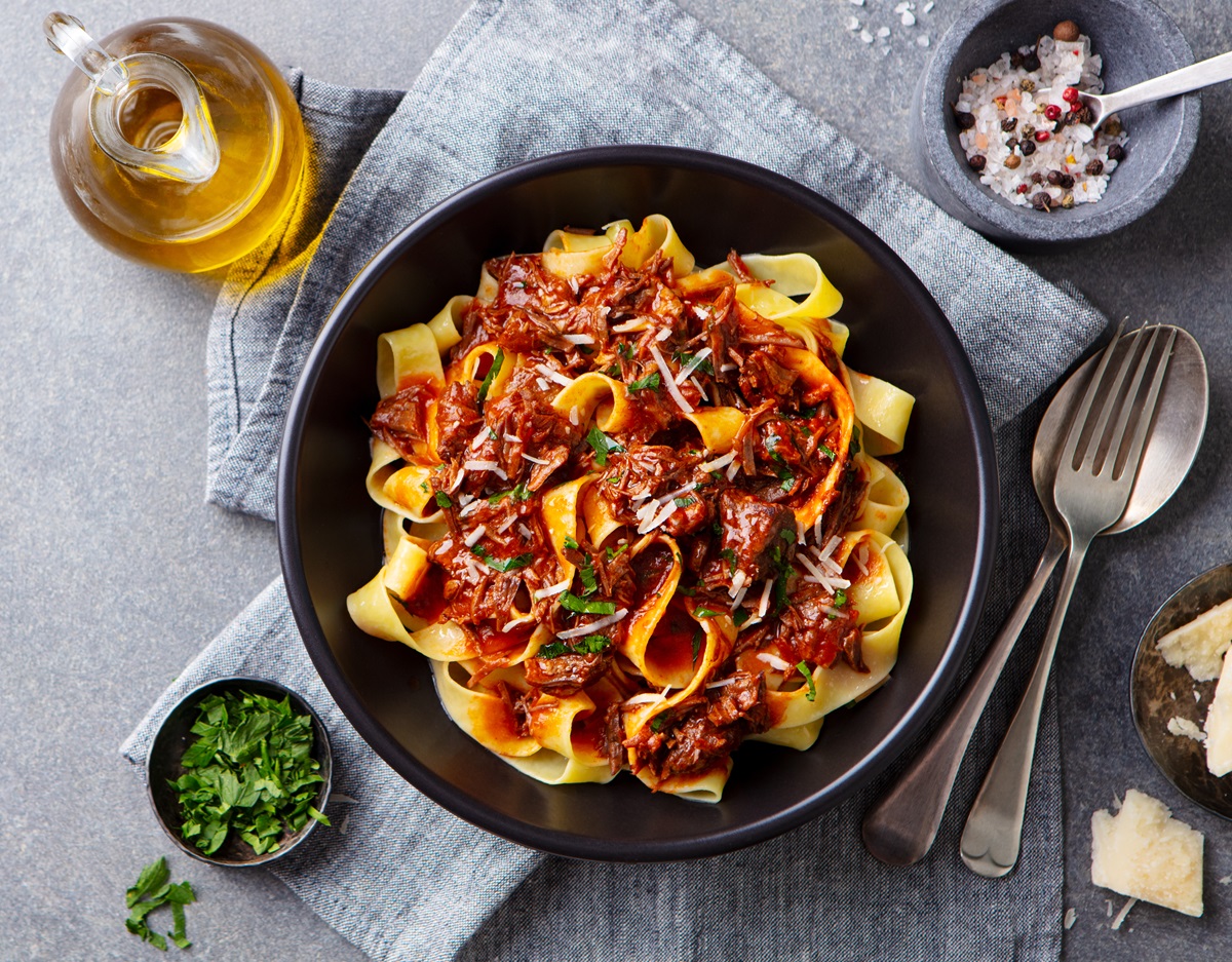 Pasta,Fettuccine,With,Beef,Ragout,Sauce,In,Black,Bowl.,Grey