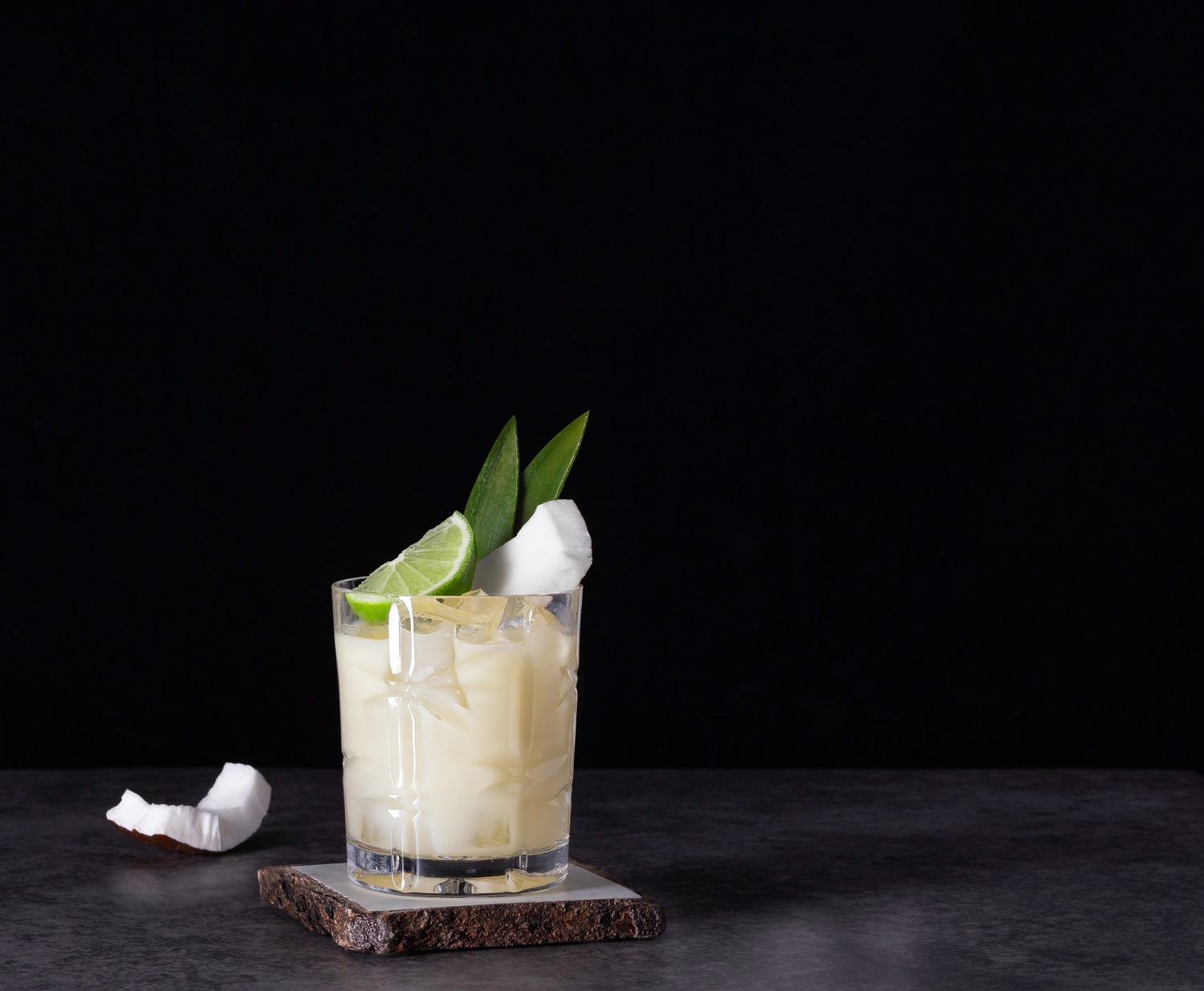 Piña,Colada,On,The,Rocks,With,Lime,And,Coconut,Garnish