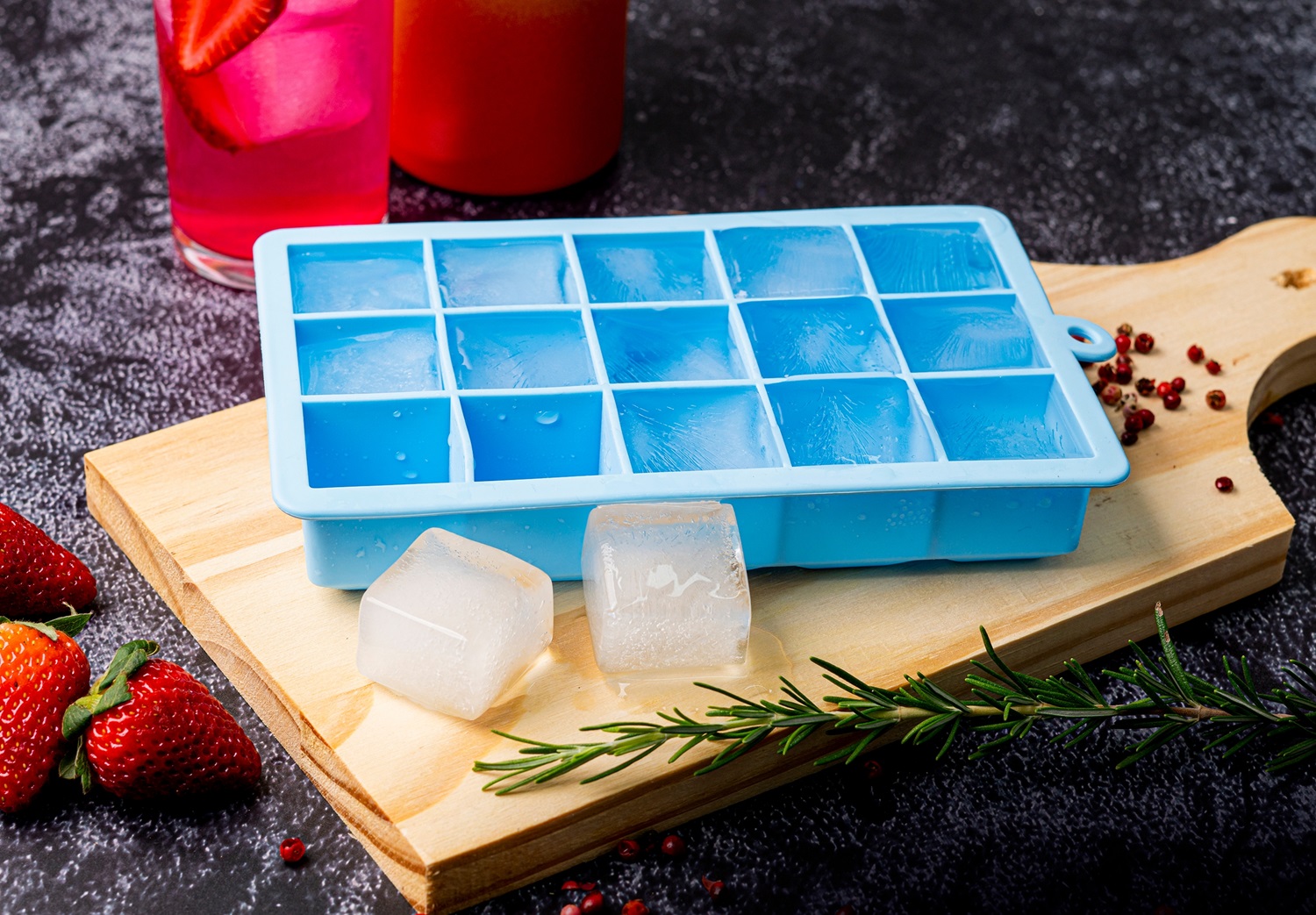 Blue,Silicone,Ice,Cube,Tray,On,Table,With,Fruit,And