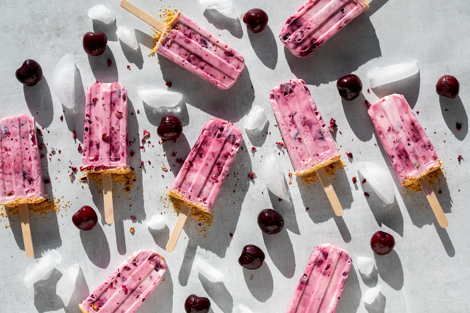 Cherry,Yogurt,Popsicles,Scattered,Around,On,A,Light,Surface,In